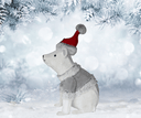Polar bear figurine wearing a Santa hat and scarf in a snowy forest setting