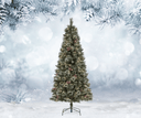 Frosted artificial Christmas tree in a snowy landscape with pine branches.