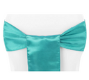 A dark turquoise chair sash tied in a bow on a white chair cover.