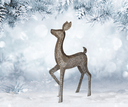 Decorative deer figure in a snowy forest setting