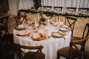 Decorated table with place settings and floral arrangements in a formal setting.