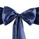 A navy blue satin chair sash tied in a bow.