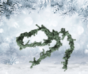 Decorative fake pine garland on a snowy background