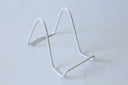 A small white metal easel on a plain background.