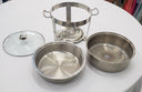 Set of stainless steel cookware including pots and a lid on a white surface.
